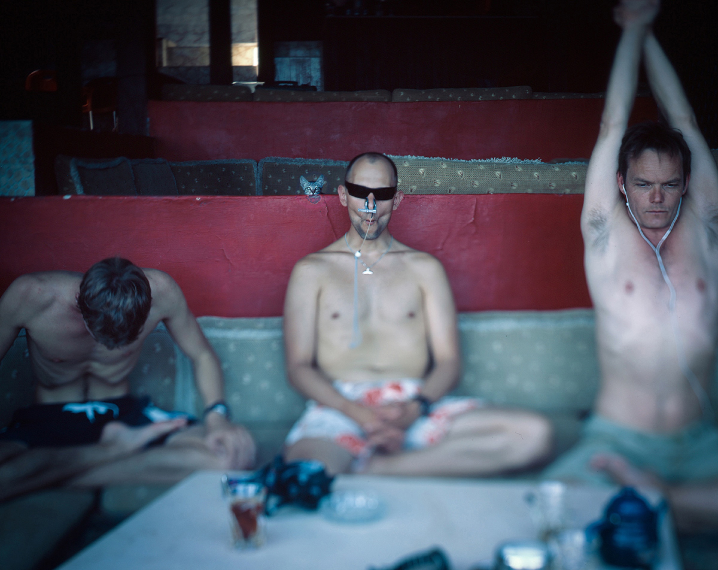 Adjusting goggles against a dark mountain — last gesture before the dive