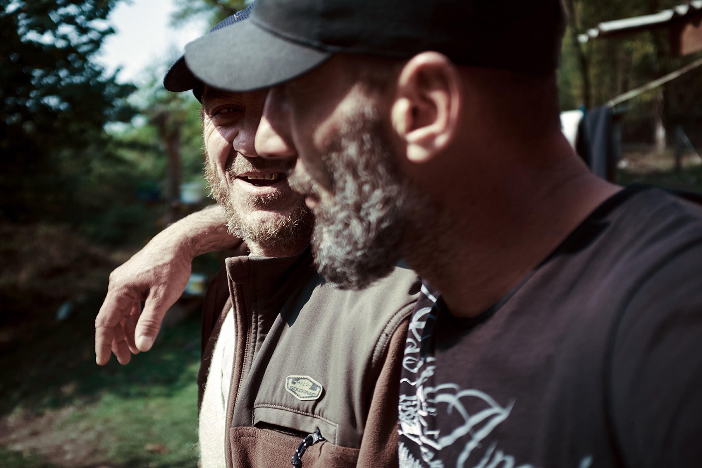 Two older men in close conversation, outdoors — Pankisi Valley