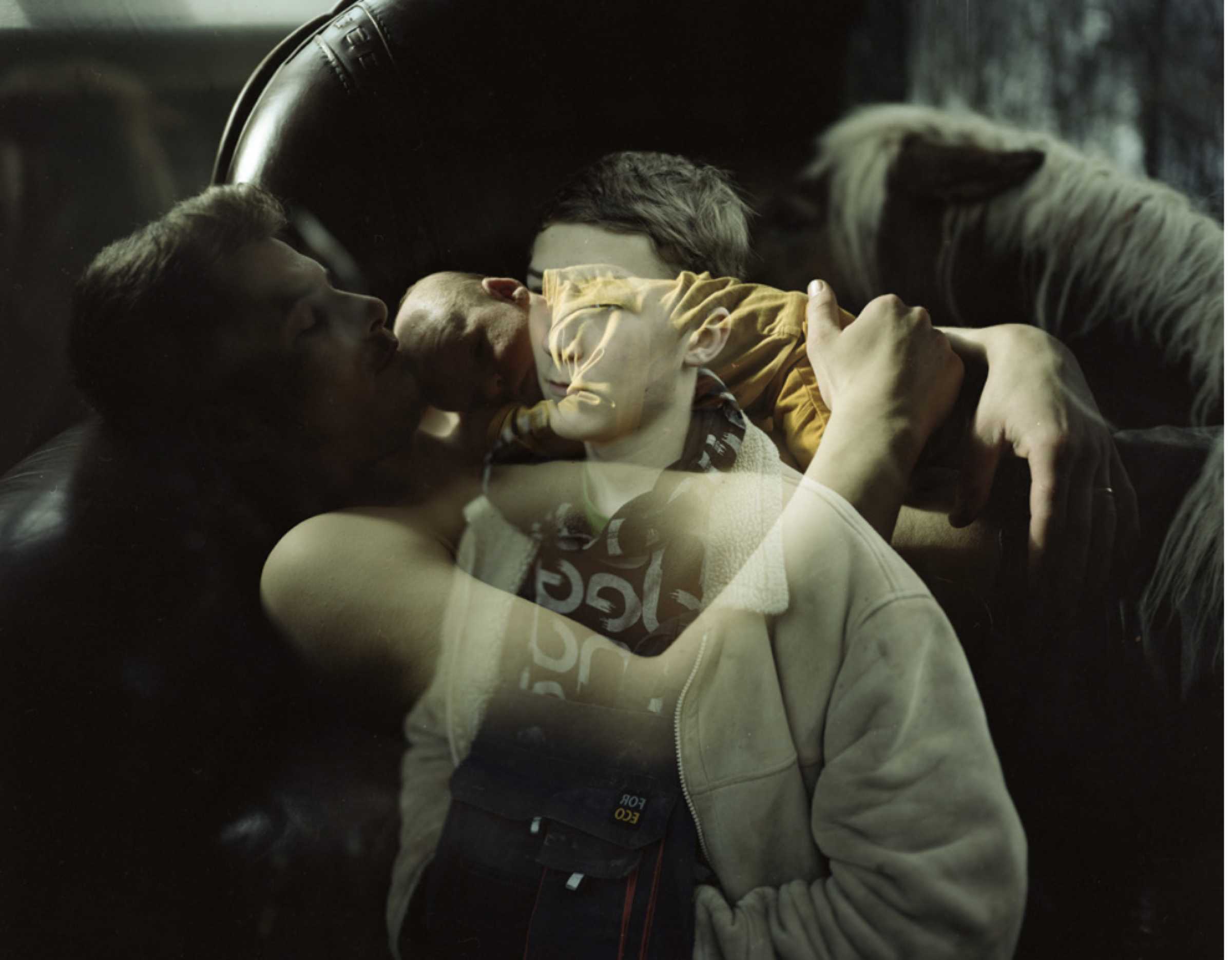 Double exposure — a young boy and a horse, layered — Podlasie